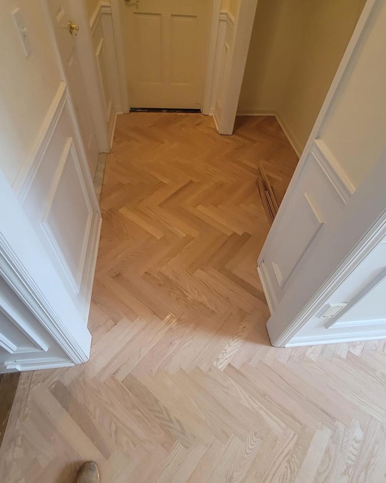 Herringbone hardwood floor in a bright entryway