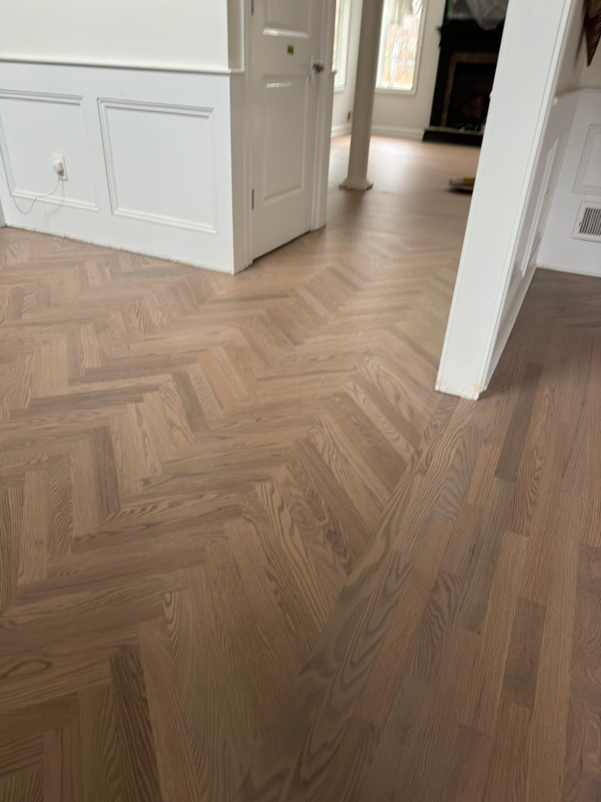 Light herringbone hardwood floor near a fireplace